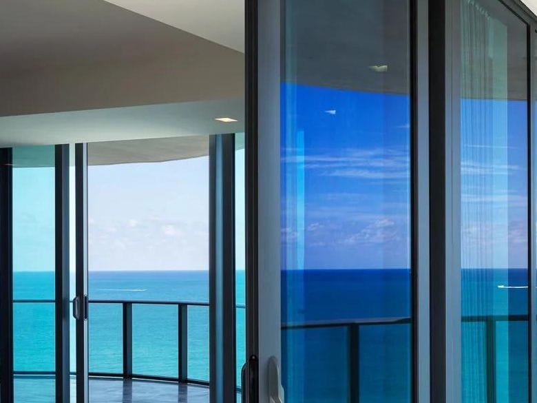 Sliding doors opening onto a balcony walking surface, showing the threshold and door track